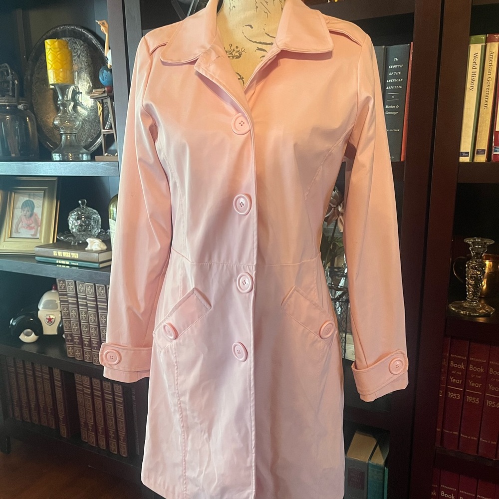 Cute, pink raincoat with big button details.